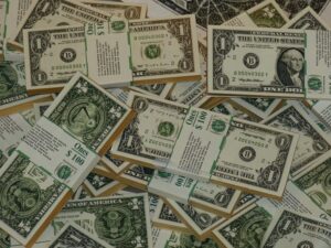 A pile of 1 dollar bills banded together | unrestricted grants for nonprofits