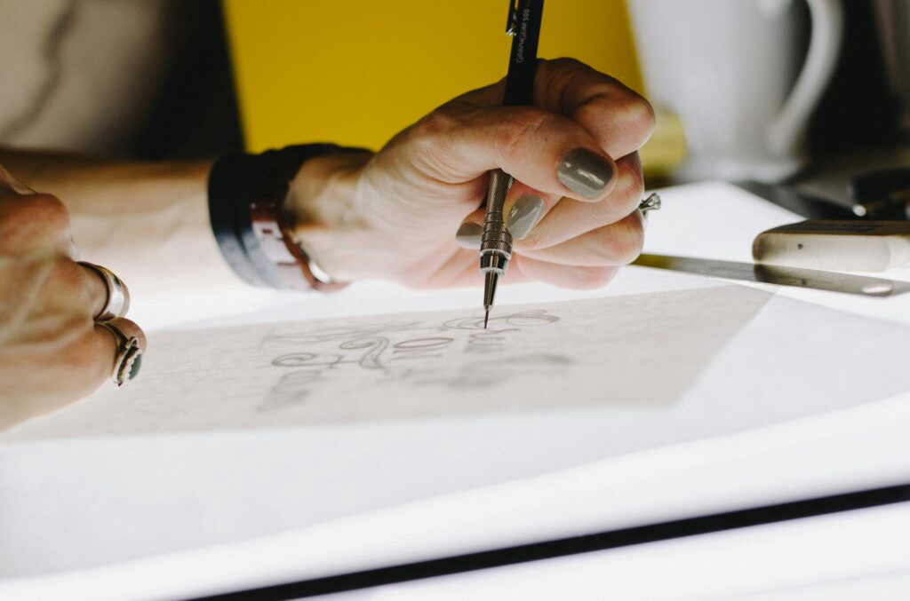 a person showing how to create a logo for your business