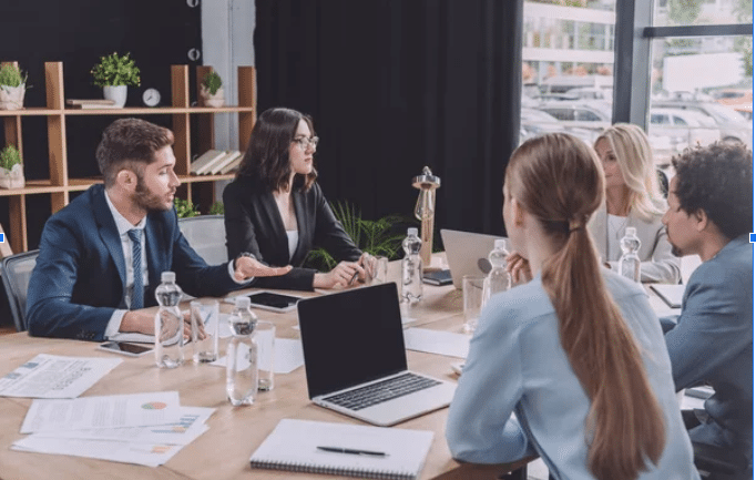 A group of 5 people having a meeting about business. [Core Principles of Branding for Local Businesses]
